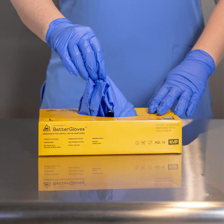 Image of person pulling BetterGloves out of their box, which is yellow with dark text.