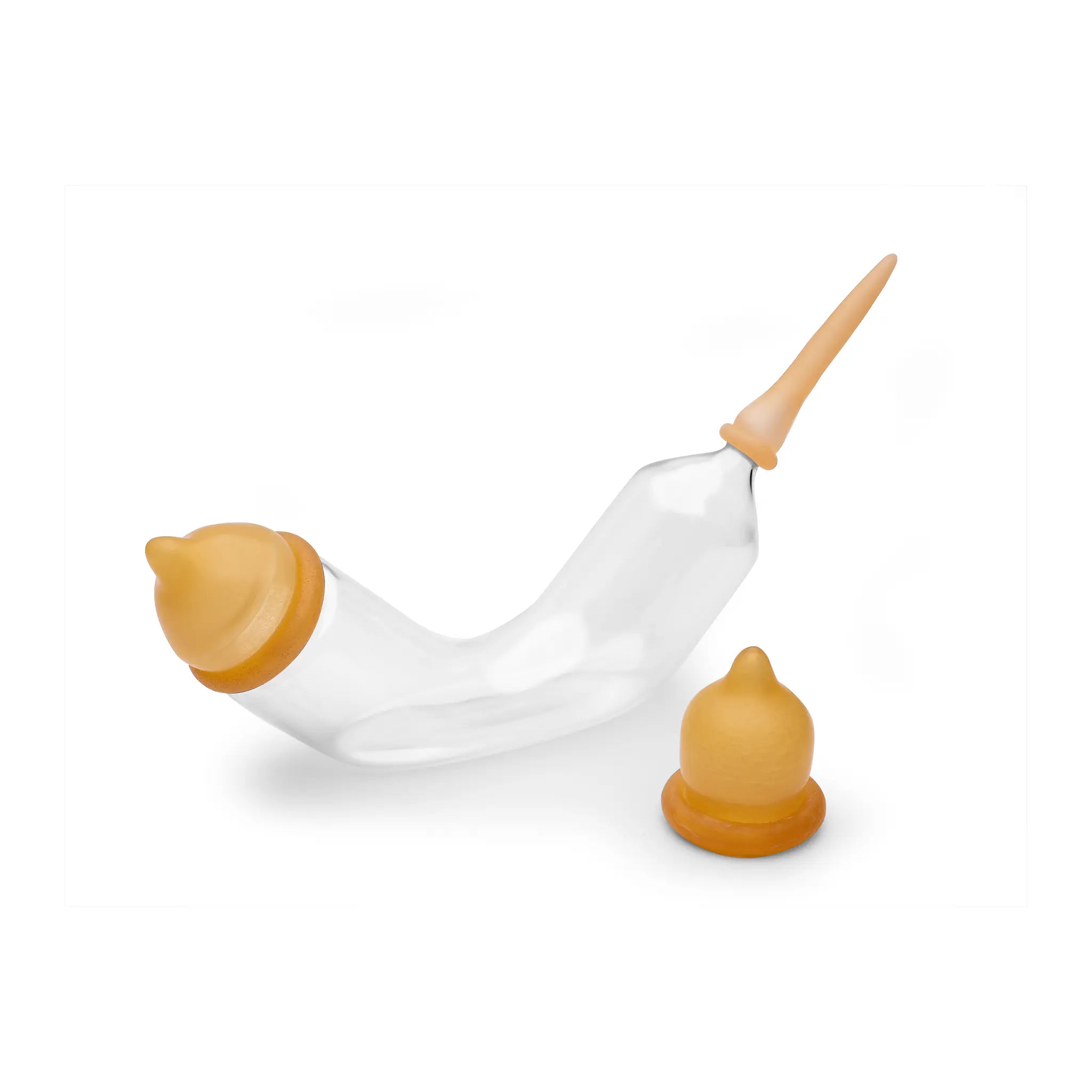 Image of Catac's glass banana-shaped bottle with a bottle valve and small teat attached, with another bottle valve in the foreground of the photo.