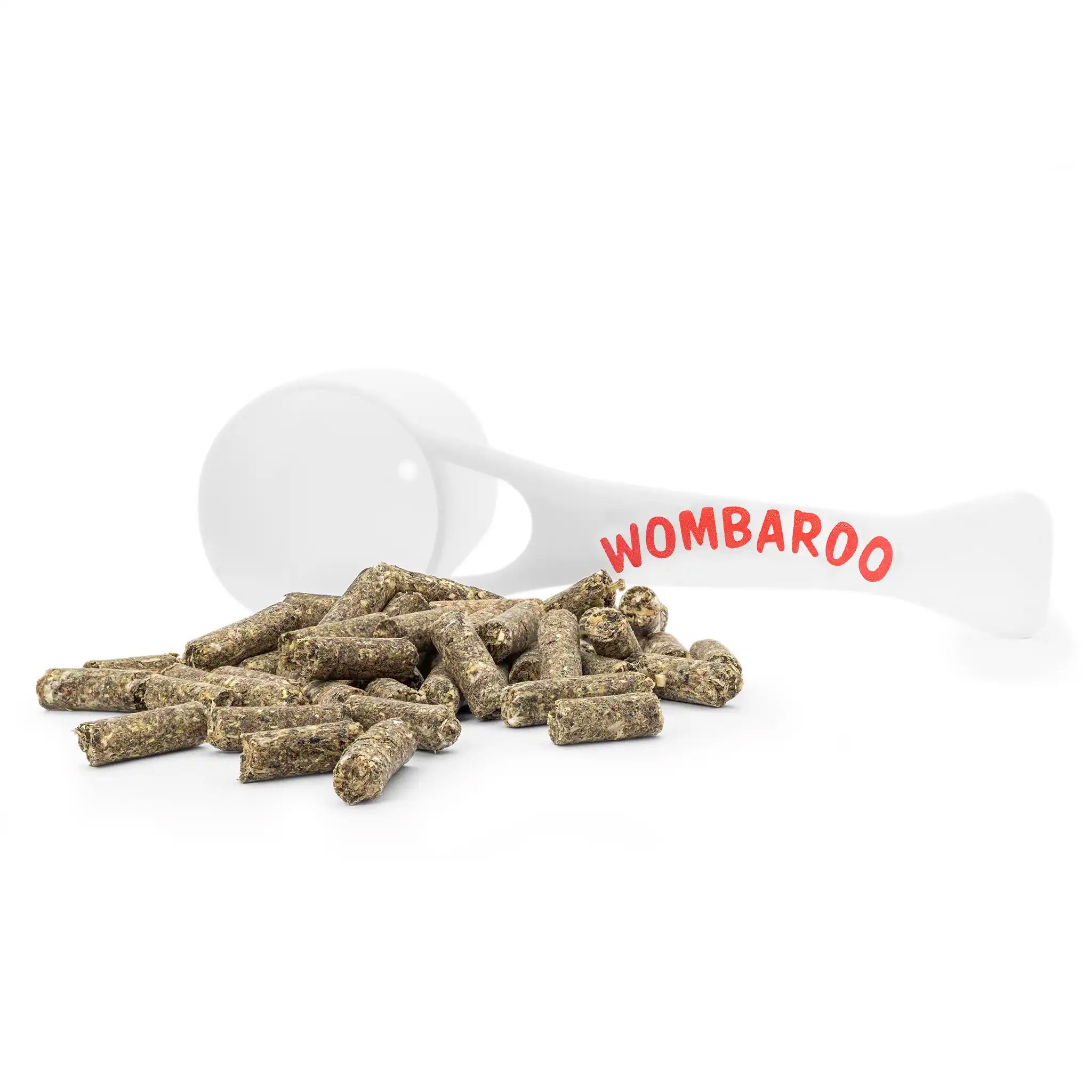 Image of Wombaroo Clover Pellets laid out on a white background, alongside the small Wombaroo branded scoop that is included with your purchase.